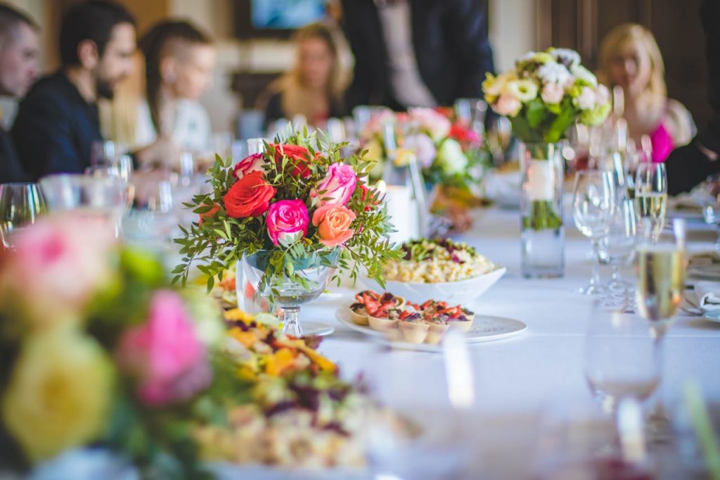 pexels-photo-1123254 Beautifully set dining table with vibrant floral arrangements and elegant tableware.